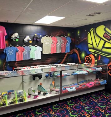 A store display featuring a skateboard alongside various skateboard shoes for sale.